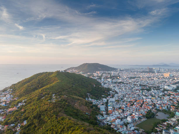 istock Panoramic coastal Vung Tau view from above, with waves, coastline, streets, coconut trees, Mount Nho in Vietnam behind the statue of Christ the King 1882497638