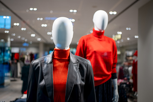 lifeless mannequins wearing stylish dresses in a clothing store