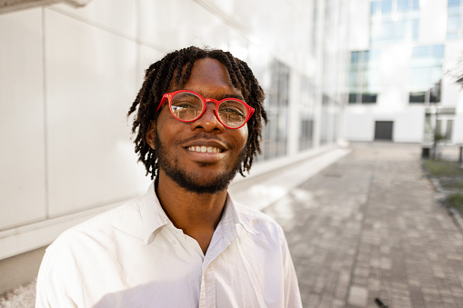 Portrait of an young male student Black ethnicity in front of the modern University