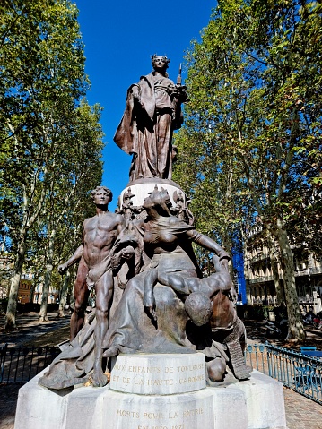 Bronze statue of the French Republic on a pedestal. At the foot of the pedestal a bronze sculpture group, showing Toulouse. Sculpor was Théophile Barrau (Villepinte 1848 - Paris 1913). the image was captured during autumns season.
