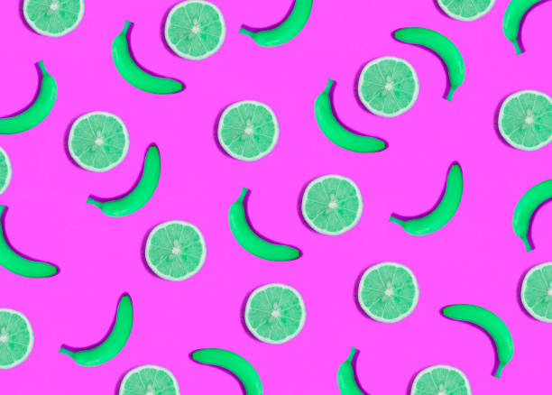 istock Green banana and lemon on the pink background. Flat lay. Pattern. Top view. 1882559787