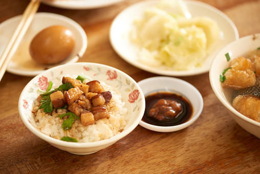 Taiwan traditional food Braised pork rice (Lu Rou Fan).\nBraised meat over cooked rice, famous and delicious street food in Taiwan.\nTaiwanese traditional famous and delicious street food in Taiwan, traditional cuisine in Taiwan. Close up of top view Chinese style food, usually can be founded in night market.