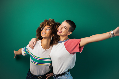 Studio portrait of the two best female friends of different ethnicity having fun together.
