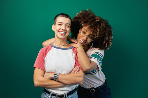 Studio portrait of the two best female friends of different ethnicity having fun together.