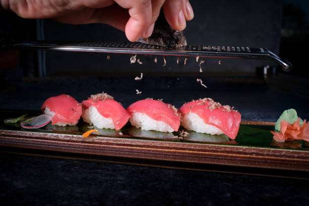 istock Crop chef decorating sushi with truffle 1882620638