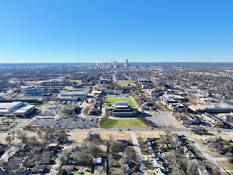 Aerial view of the University of Tulsa with the Tulsa Skyline in the background and beautiful blue skies