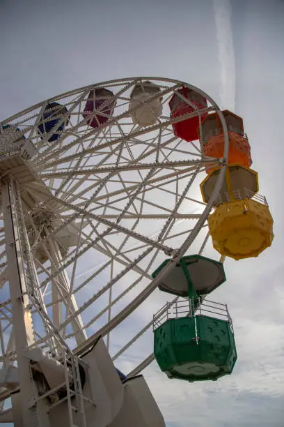 An aerial view of a vibrant-colored amusement park Ferris wheel in Tibidabo,Barcelona