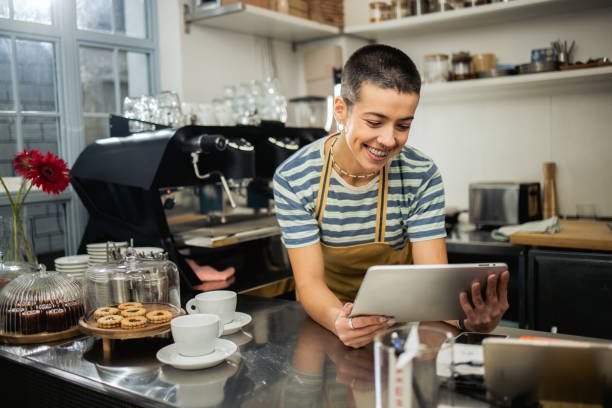 istock Portrait of a happy bartender using tablet 1882712552