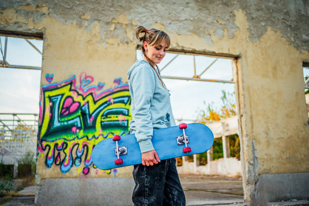 istock Cheerful young woman with a skateboard 1882792147