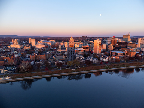 An aerial photo of sunset light illuminating the Pennsylvania State Capitol and downtown Harrisburg Pennsylvania.