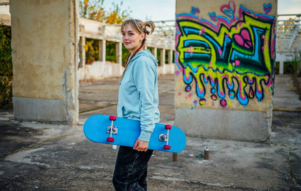 istock Cheerful young woman with a skateboard 1882792656