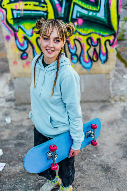 istock Smiling young woman with a skateboard 1882793175