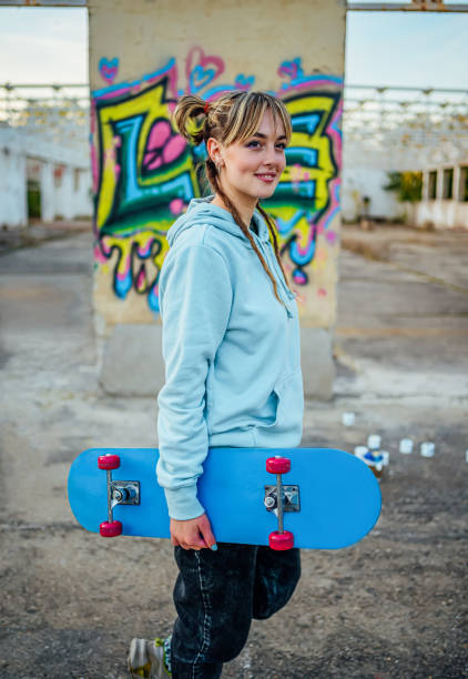 istock Smiling young woman with a skateboard 1882793688