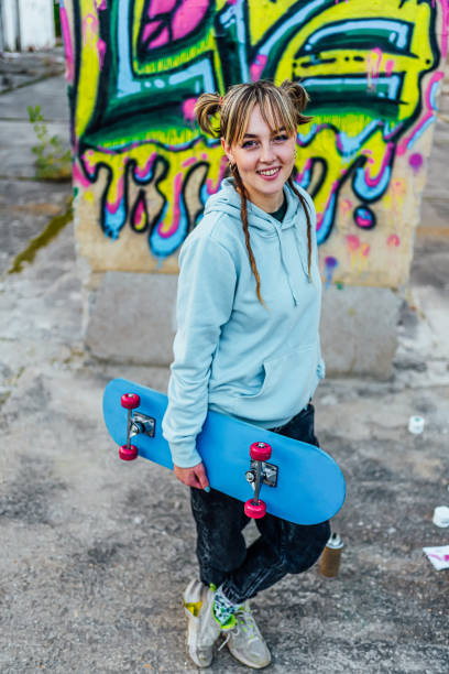 istock Smiling young woman with a skateboard 1882795753