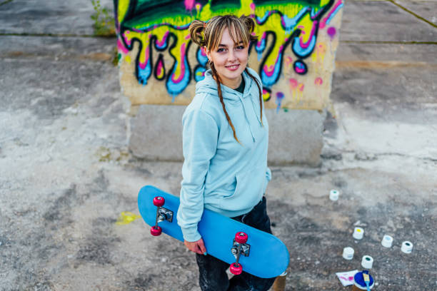 istock Smiling young woman with a skateboard 1882796269