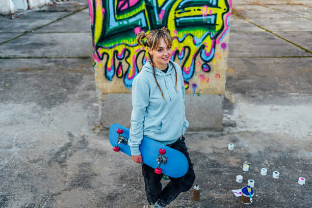 istock Smiling young woman with a skateboard 1882796774