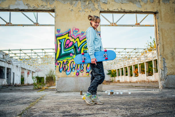 istock Cheerful young woman with a skateboard 1882830924