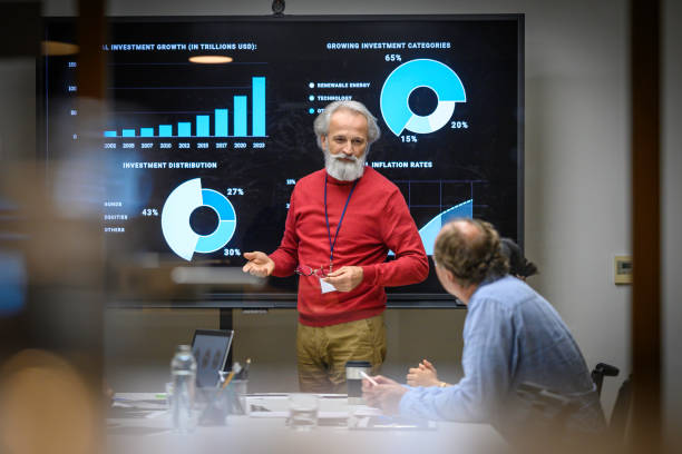 Senior man presenting report in meeting room