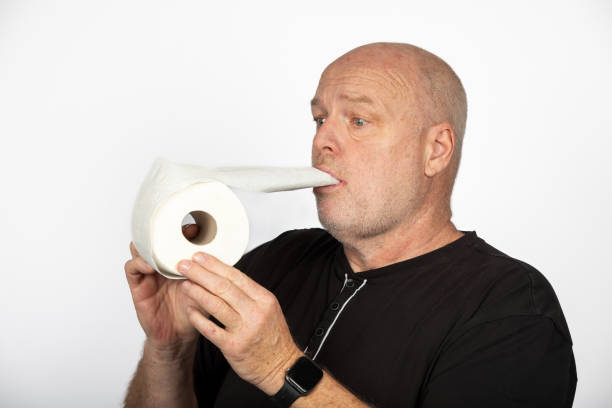 istock Quirky Madness: Middle-aged Caucasian Man with Toilet Paper Roll - White Background 1882843200