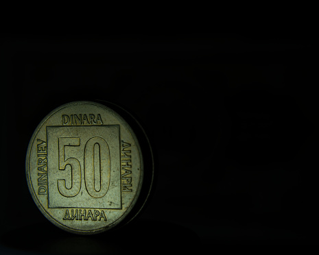 A closeup of Yugoslavian 50 dinar coin on a dark background