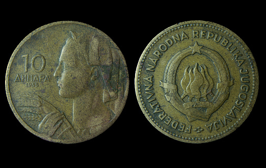 A closeup of Yugoslavian 10 dinar coin on a dark background