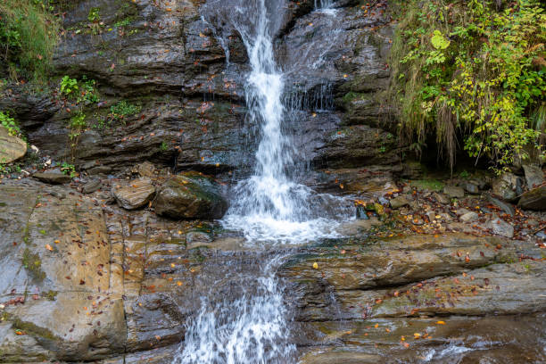 istock Majestic waterfall streaming between towering rocks in Transylvania, Romania 1882866842