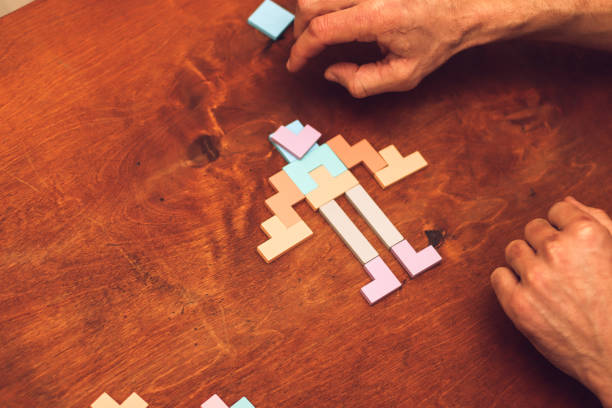 wooden multi-colored elements of logic puzzles during the game on the table