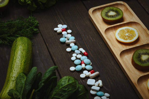 Hip of pills with sliced lemon and kiwi stock photo