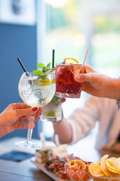 istock Friends enjoying a meal together, featuring appetizers and beverages on a table 1882912324