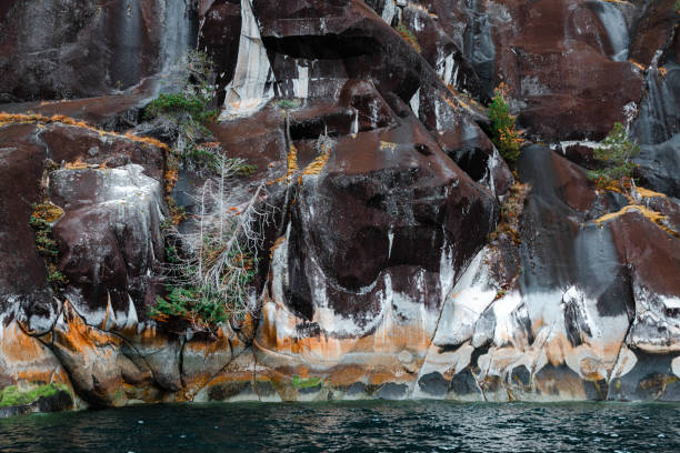 Colourful rock formation over the ocean inlet.