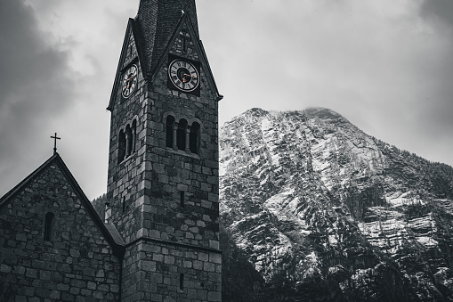 An Evangelical Church situated in Hallstatt, Austria, with a majestic mountain in the background