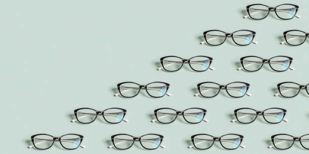 istock Glasses for vision on a green background with copy space. Optical store, vision test, stylish glasses concept. Banner 1882995797
