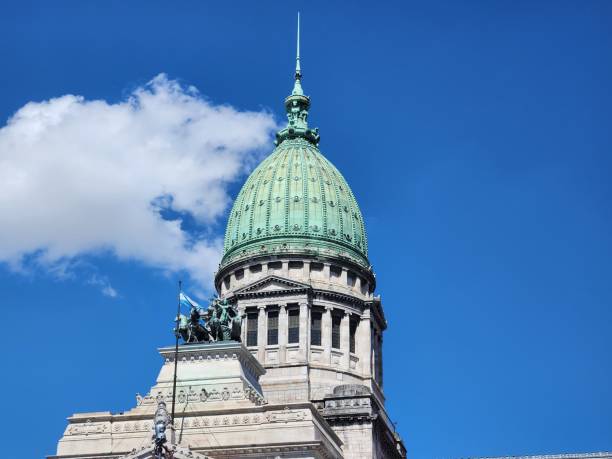 istock a building with a green roof on top with two birds perched on it 1883018524