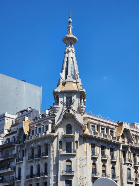 istock an old building near some very tall buildings on a bright blue sky day 1883019021
