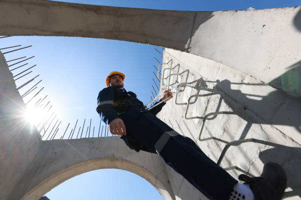 Civil engineer with safety harness climb to check the job progress