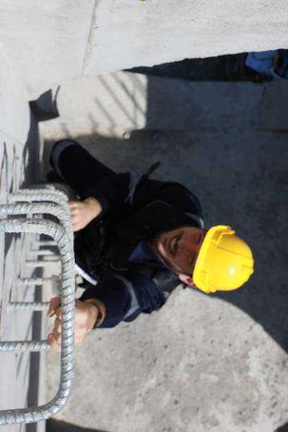 istock Civil engineer with safety harness climb to check the job progress 1883021083