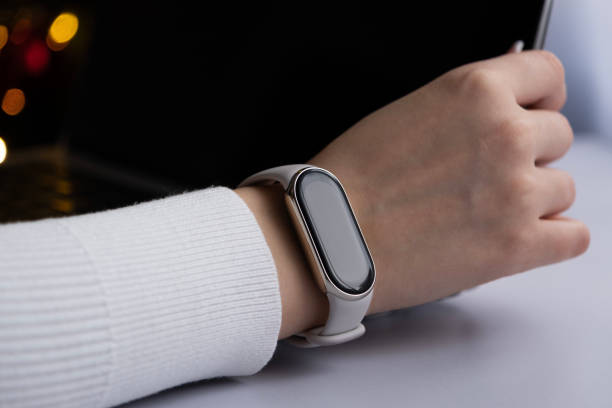 istock Female hand using laptop with smart watches on a wrist 1883040336