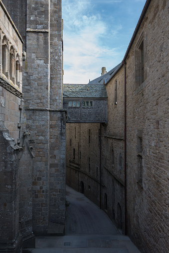 Architectural detail of the passage that connects two buildings in the old town of Mont Saint Michelle, there are no people on the street