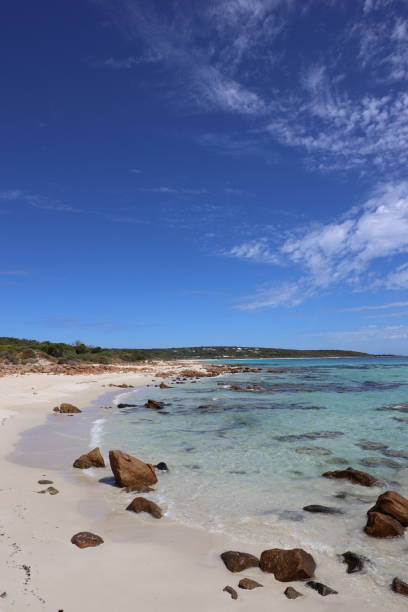 istock Landscape with an empty beach with rocks in the crystal clear water and pristine white sand 1883058803