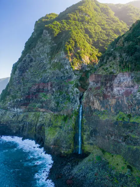 The beautiful view of cliffs and Corrego da Furna waterfall. Madeira, Portugal
