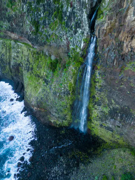 An aerial view of the cliffside and Corrego da Furna waterfall. Madeira, Portugal