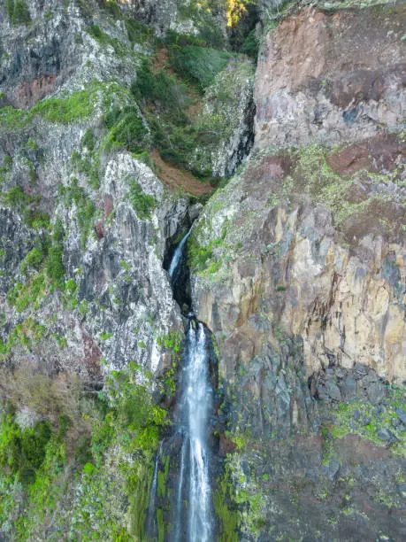 An aerial view of the cliffside and Corrego da Furna waterfall. Madeira, Portugal