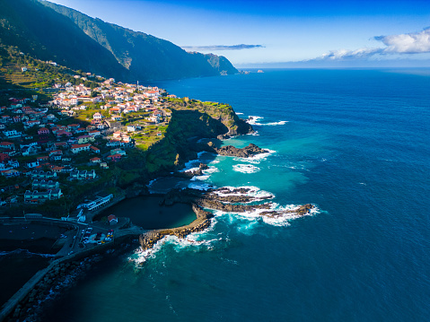A stunning aerial view of a picturesque coastal town on a cliffside. Seixal, Madeira, Portugal