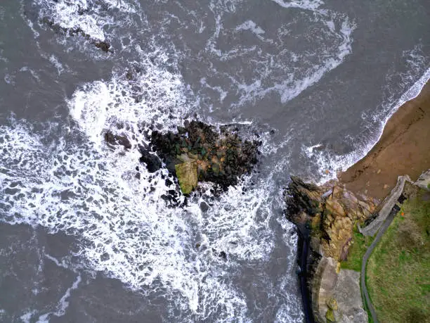 An aerial view of the rocks and ocean waves. Charley's Garden, Collywell Bay, Seaton Sluice