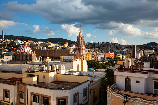 A view from a rooftop towards the end of the day, at part of  city of Zacatecas, a famous old mining town now a UNESCO world heritage site and a popular tourist destination.