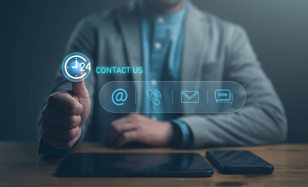 istock Contact us or Customer support hotline, people connect, Businessman using tablet and smartphone and touching on virtual screen contact icons (email, address, live chat, telephone). Customer service 1883176748