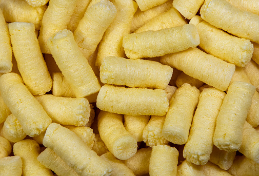 A close-up of many corn puffs