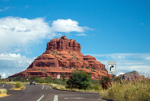 Blue sky and white clouds contrast nicely with the beautiful Bell Rock formation in Arizona.