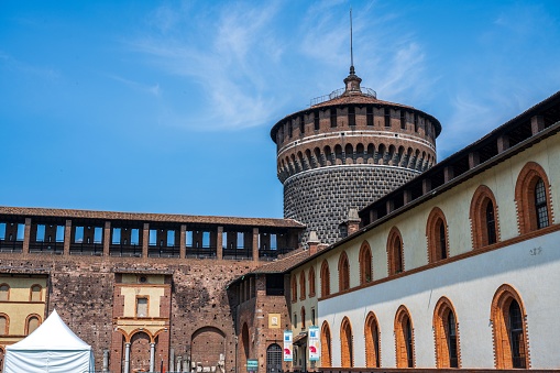 Milan, Italy – June 19, 2023: An exterior shot of an aged building with multiple windows, showcasing its old-fashioned architecture (Milan Castle)