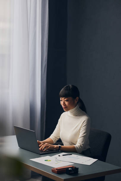 istock A Happy Beautiful Asian Woman Typing On Her Computer While Working In The Office 1883285995